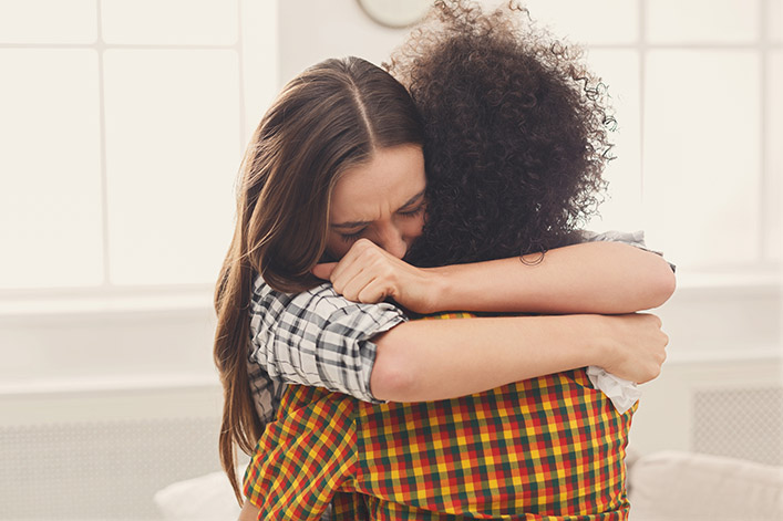 two people in an emotional embraces, faces obscured